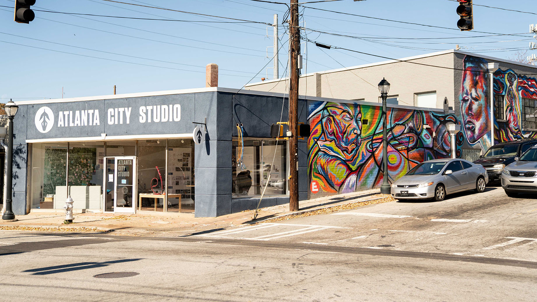 Corner building mural beside the Atlanta City Studio storefront painted by muralist Corey Barksdale