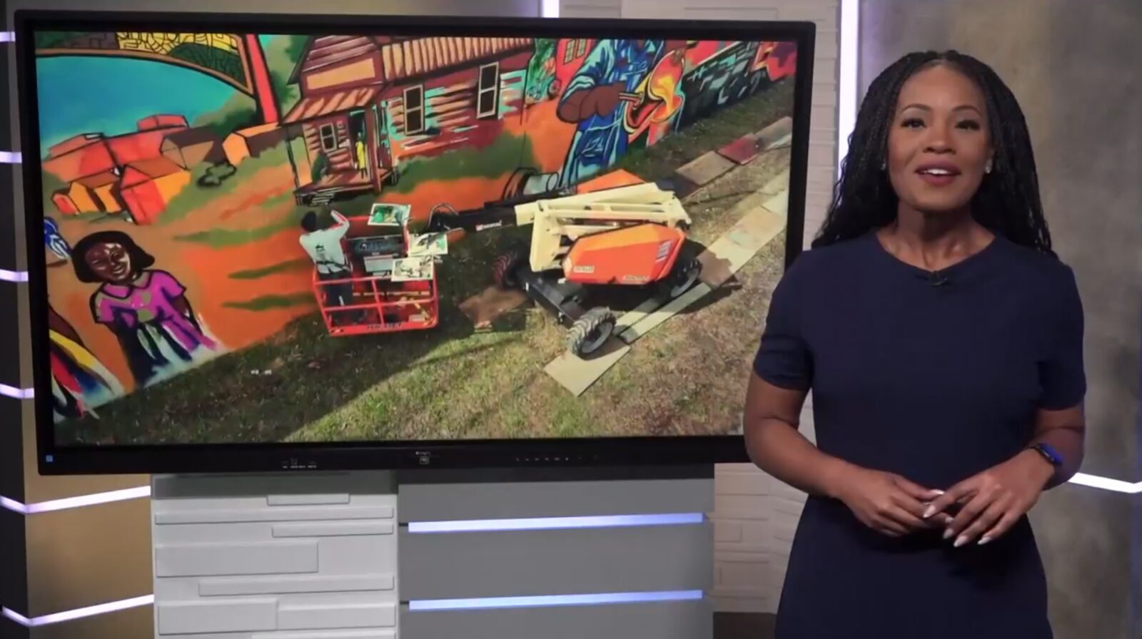 11Alive Atlanta news anchor presenting a segment on Corey Barksdale's Blandtown mural