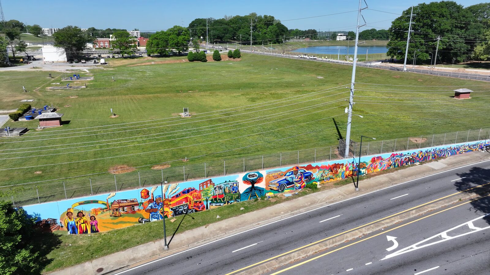 Aerial drone view of the completed Blandtown mural spanning the retaining wall along Northside Drive in Atlanta