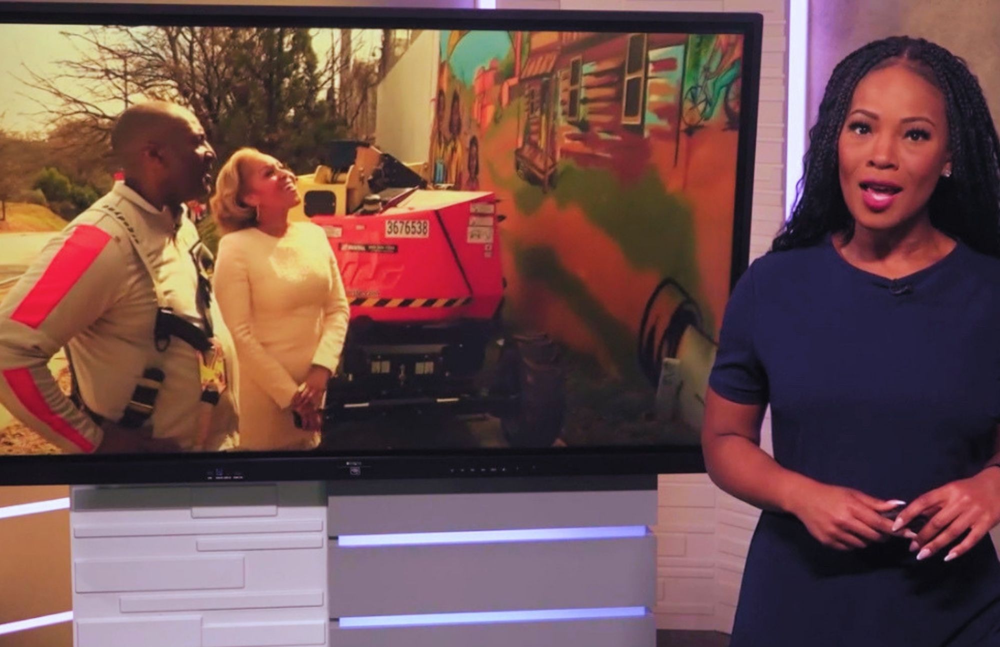 Local Atlanta news anchor reporting on Corey Barksdale's Blandtown mural