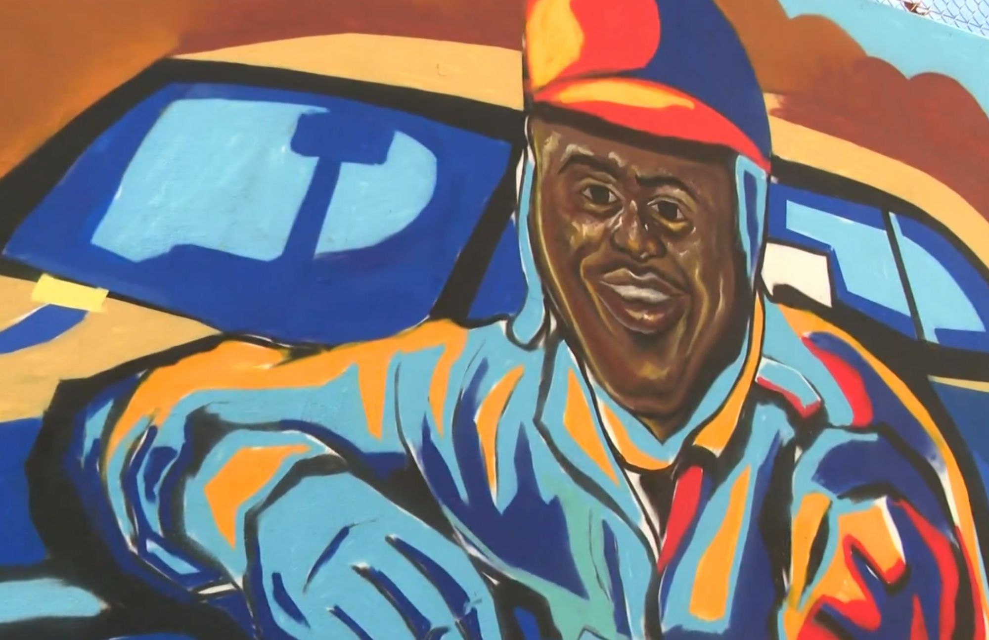Detail portrait of a Black railroad worker from the Blandtown mural by Corey Barksdale