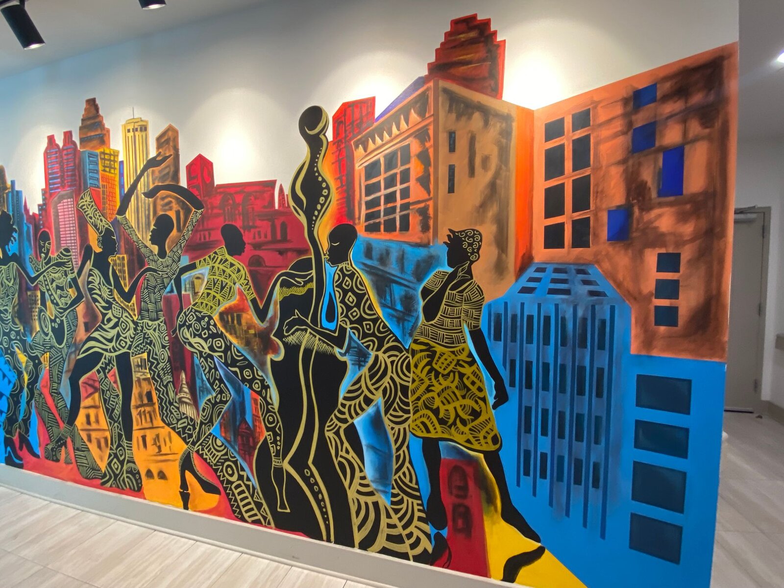 Angled wide view of the completed Decatur East mural wrapping around the hallway corner at The Link at Columbia