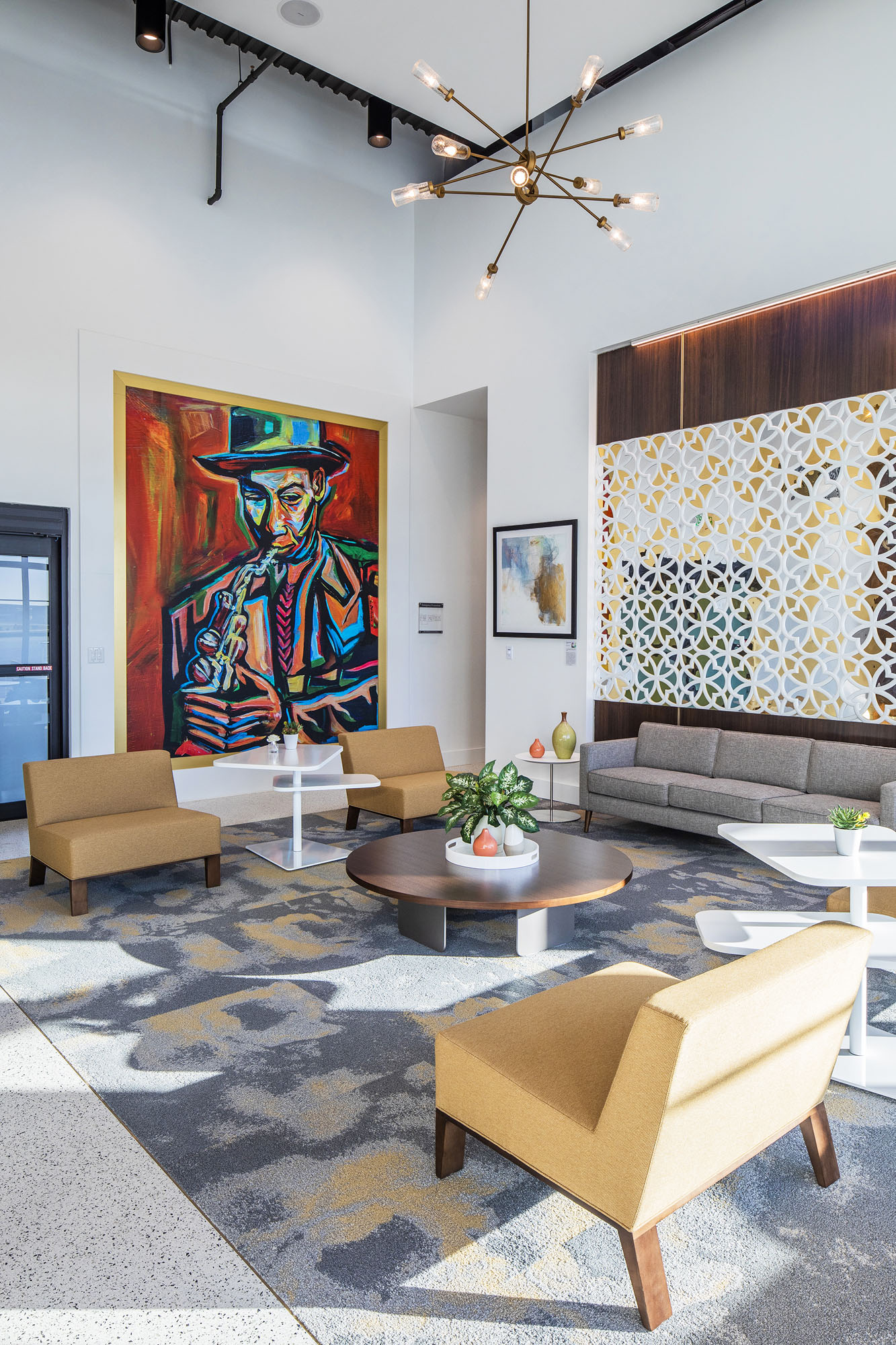 Corey Barksdale mural of a jazz saxophonist, framed in gold above the seating area of the Signature Aviation Executive Terminal lounge