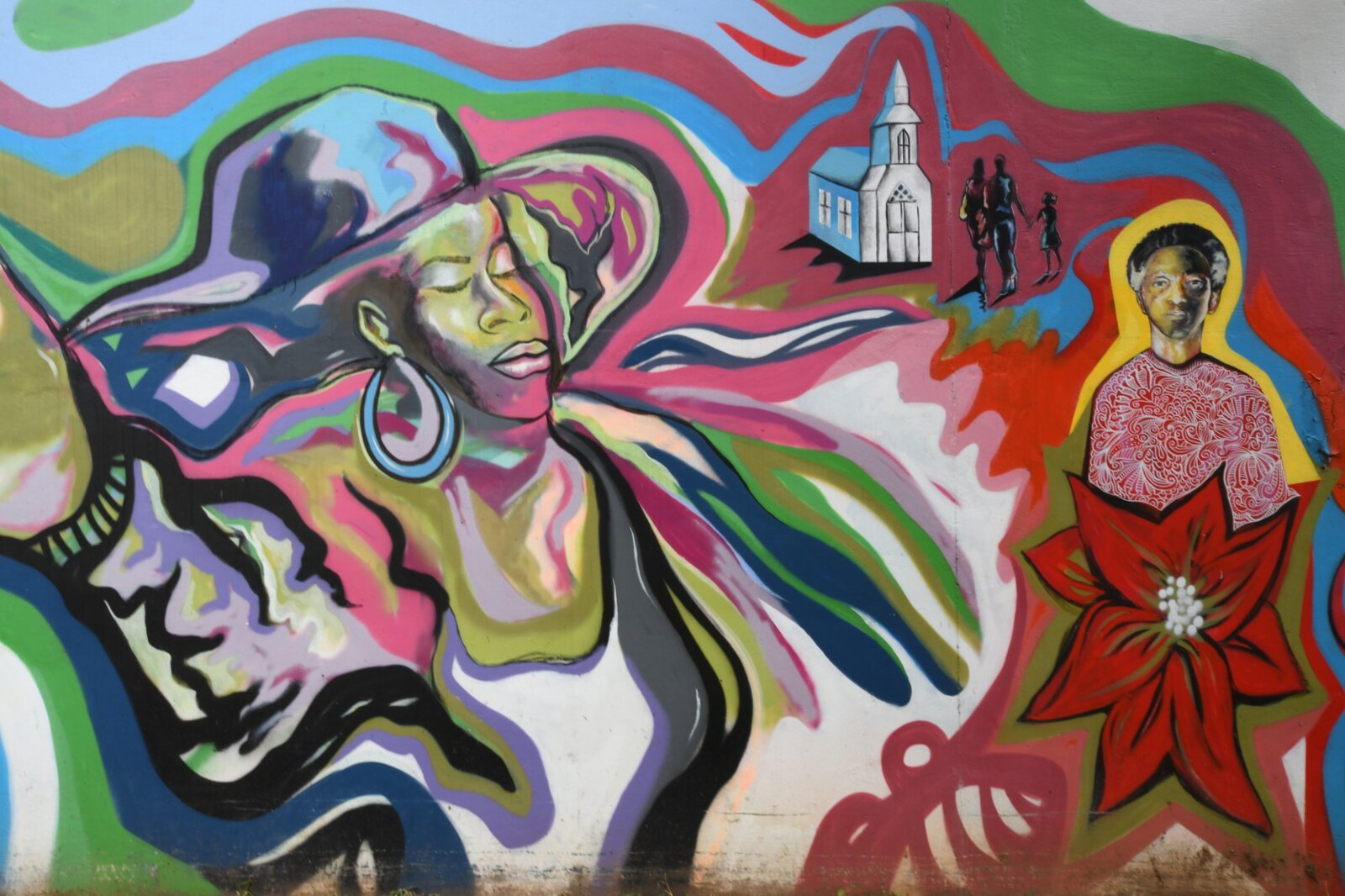 Wide view of the church, family, and haloed portrait panel of the Pittman Park mural by Atlanta muralist Corey Barksdale
