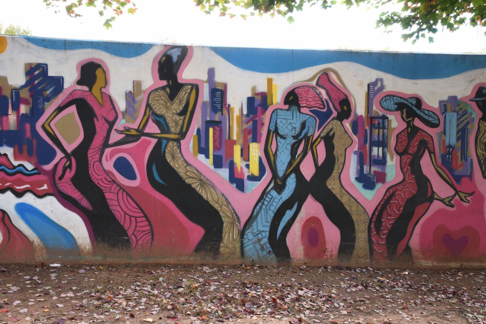 Patterned dancers against the Atlanta skyline, Pittman Park mural by Atlanta mural painter Corey Barksdale