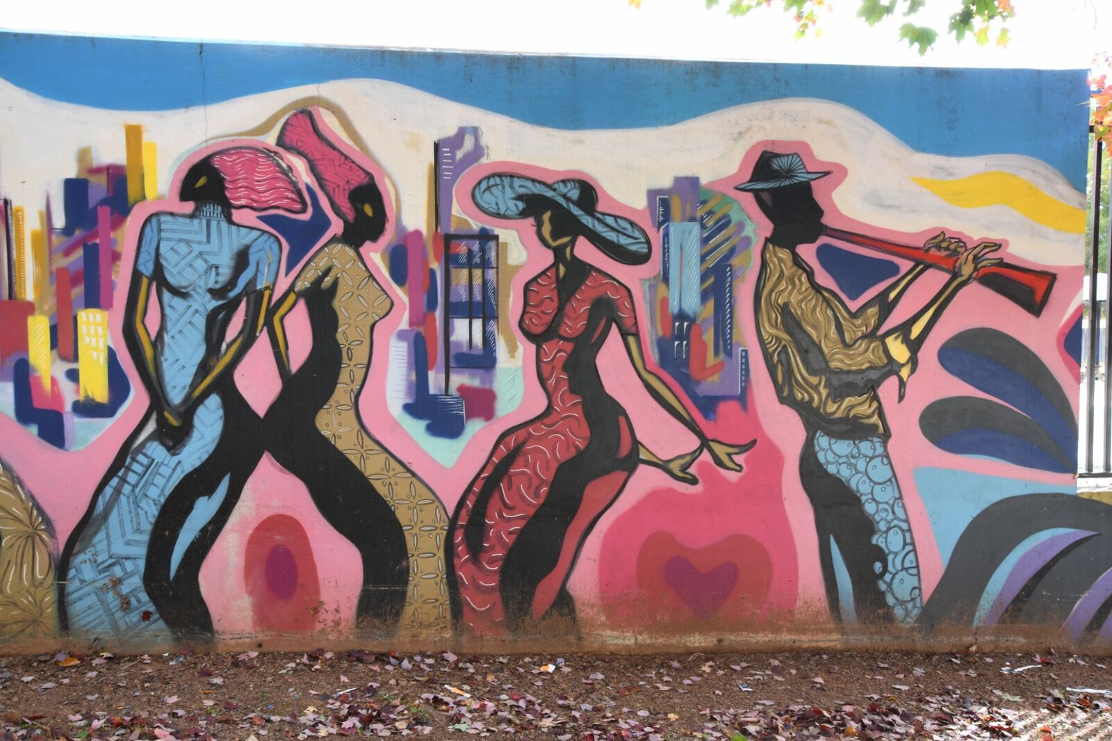 Dancers and a trumpet player against the Atlanta skyline, Pittman Park mural by Pittsburgh Atlanta muralist Corey Barksdale