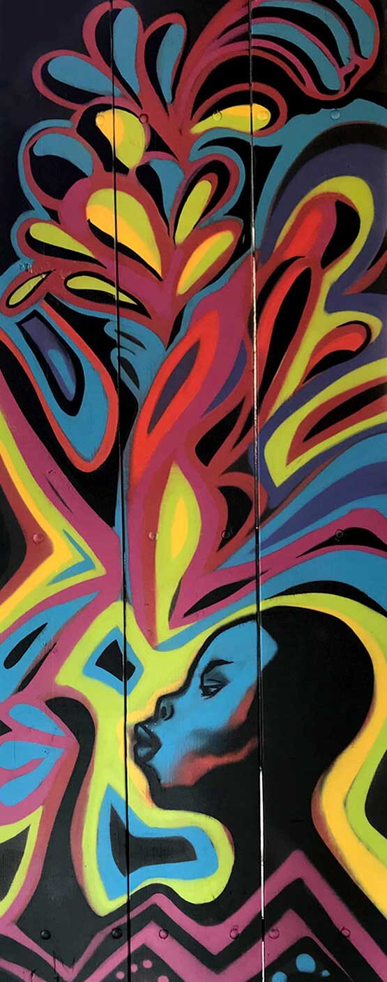 Colorful profile portrait painted on a park utility box near Turner Field, by Atlanta muralist Corey Barksdale